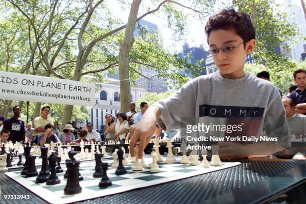 Ten-year-old chess prodigy Fabiano Caruana makes his move on one of 15 opponents he took on simultaneously in Bryant Park. Caruana, playing to...