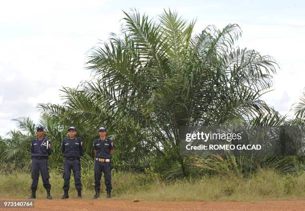 This photograph taken during a media trip organized by the palm oil unit of Sinar Mas, PT SMART , on August 2, 2010 company guards are posted for...