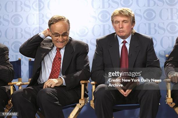 Mayor Rudy Giuliani considers a question as Donald Trump looks on at news conference at the GM Building, where CBS announced that Bryant Gumbel will...