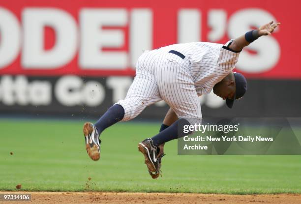 New York Yankees' shortstop Wilson Betemit ranges to his left to stop a ball, hit for a single in the second inning, from heading into the outfield...