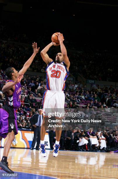 New York Knicks' Allan Houston shoots over Toronto Raptors' Morris Peterson during action at Madison Square Garden. Houston scored a season high 34...