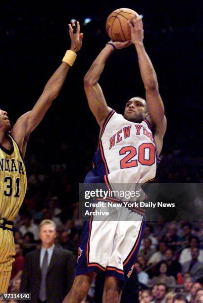 New York Knicks' Allan Houston takes a jump shot over Indiana Pacers' Reggie Miller in Game 6 of NBA Eastern Conference finals at the Garden.,