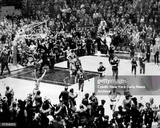 New York Knicks and fans go wild on the court at Madison Square Garden, after the team defeated the Los Angeles Lakers to win the NBA Championship....