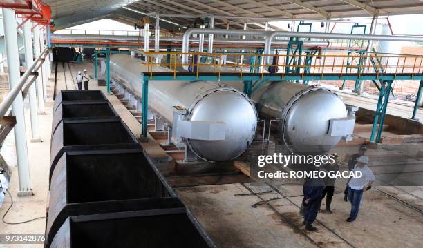 In this photograph taken during a media trip organized by the palm oil unit of Sinar Mas, PT SMART , on August 2, 2010 plant personnel talk at a...