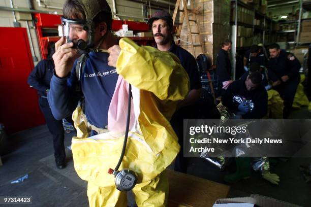 Trainees prepare hazmat suits for the obstacle course during Special Operations training at the Fire Academy on Randall's Island. The first class...