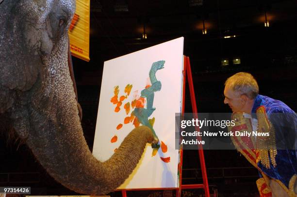 Nicole the elephant, from Ringling Bros. And Barnum & Bailey Circus, shows off her artistic side as she paints a work for children of the local...