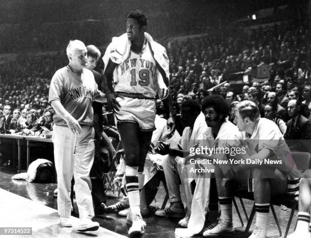 New York Knicks' captain Willis Reed [19] could lend little more than moral support to the Knicks in their decisive 107-100 victory over the Los...