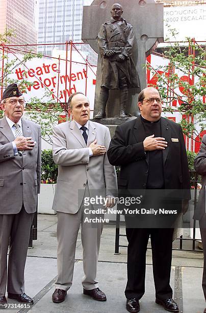 Mayor Rudy Giuliani is flanked by Joseph Healy, former commanding officer of the 69th New York Infantry, and the Rev. Peter Colapietro, pastor of...