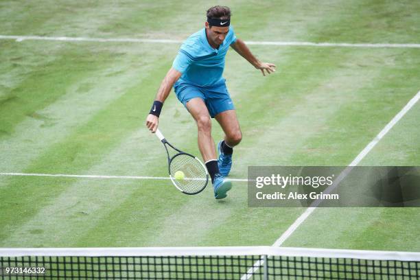 Roger Federer of Switzerland plays a backhand to Mischa Zverev of Germany during day 3 of the Mercedes Cup at Tennisclub Weissenhof on June 13, 2018...