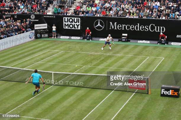 Roger Federer of Switzerland plays a volley to Mischa Zverev of Germany during day 3 of the Mercedes Cup at Tennisclub Weissenhof on June 13, 2018 in...
