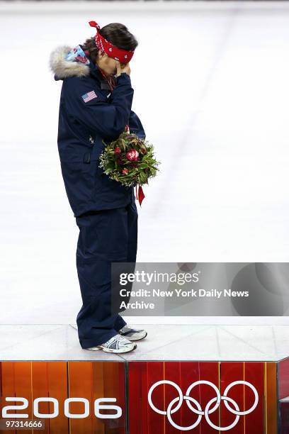 Gold medalist Apolo Anton Ohno of the U.S. Becomes emotional on the stand as America's national anthem is played during ceremonies following the...