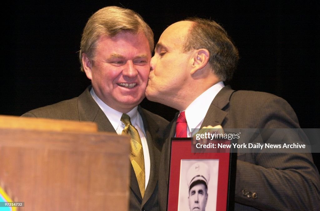 Mayor Rudy Giuliani kisses Fire Commissioner Thomas Von Esse