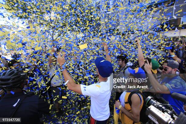 Stephen Curry of the Golden State Warriors and fans celebrate during the Victory Parade on June 12, 2018 in Oakland, California. The Golden State...