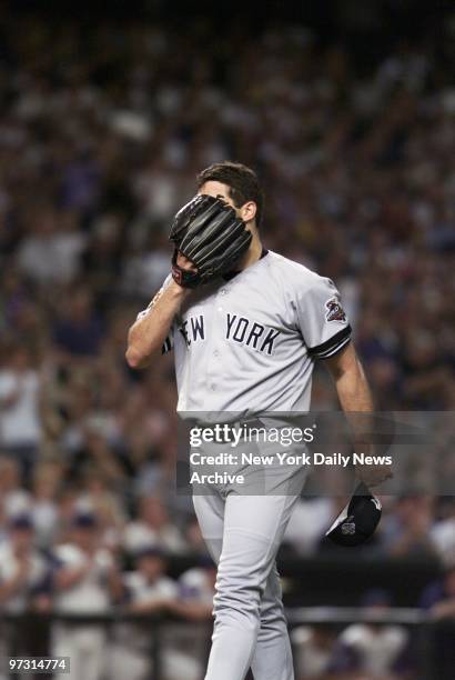 New York Yankees' starter Andy Pettitte can't bear to look as he walks off mound after giving up one run in the first inning of Game 6 of the World...