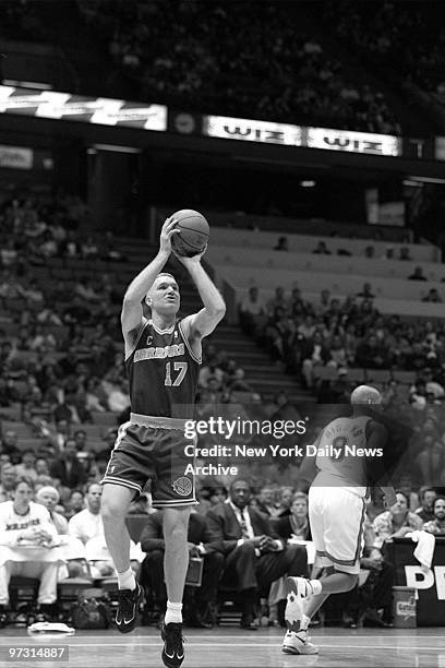 Golden State Warriors' Chris Mullin gets off a shot against the New Jersey Nets.