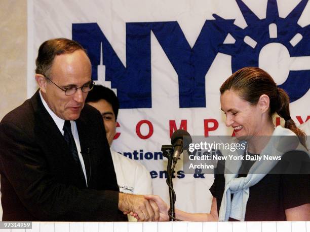 Mayor Rudy Giuliani shakes hands with Cristyne Lategano-Nicholas, head of the Convention and Visitors Bureau, at Eleven Madison Park restaurant. They...