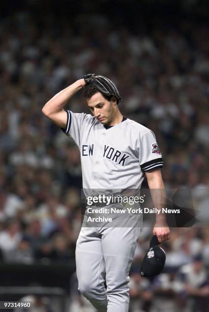 New York Yankees' starter Andy Pettitte holds his head as he walks off mound after giving up one run in the first inning of Game 6 of the World...