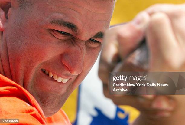 Staff Sgt. Derek Caputi strains against his opponent during the third annual International Arm Wrestling Championship aboard the Intrepid...