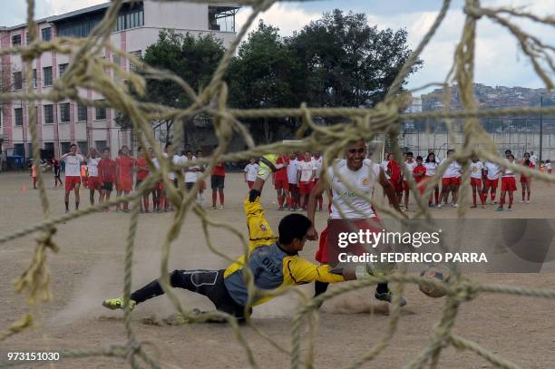 Venezuelan boys play football at the San Jose de Calasanz School in Catia neighborhood in Caracas on June 11, 2018. - In Catia -birthplace of iconic...