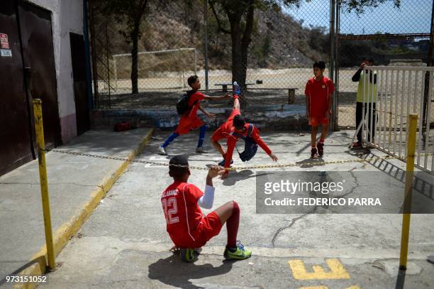 Venezuelan boys play football with a paper ball at the San Jose de Calasanz School in Catia neighborhood in Caracas on June 11, 2018. - In Catia...