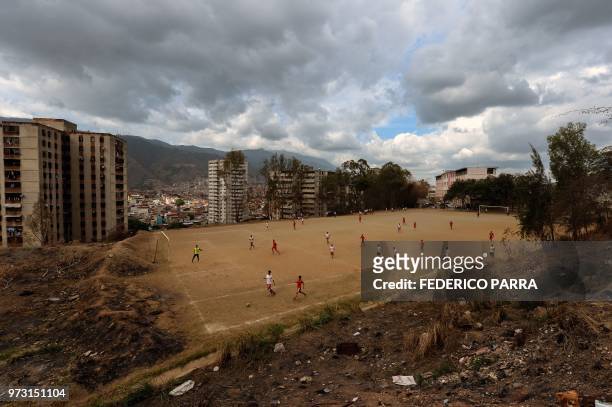 Venezuelan boys play football at the San Jose de Calasanz School in Catia neighborhood in Caracas on June 11, 2018. - In Catia -birthplace of iconic...
