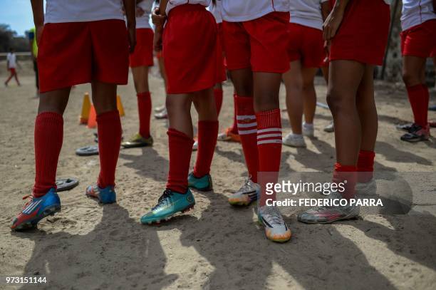 Venezuelan boys attend football classes at the field of the San Jose de Calasanz School in Catia neighborhood in Caracas on June 11, 2018. - In Catia...