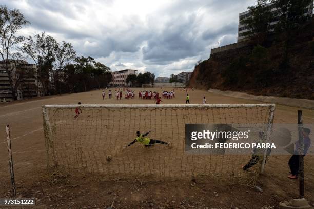 Venezuelan boys play football at the San Jose de Calasanz School in Catia neighborhood in Caracas on June 11, 2018. - In Catia -birthplace of iconic...