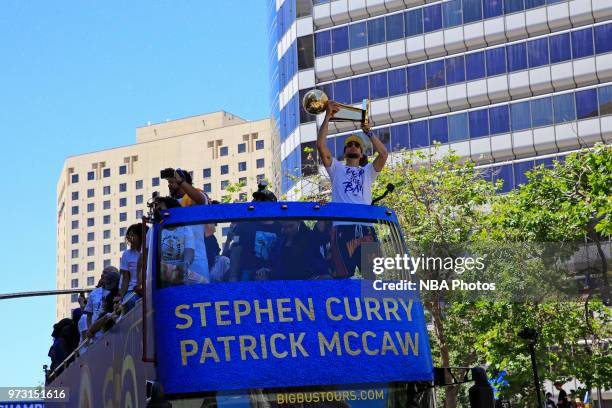 Stephen Curry of the Golden State Warriors holds up the Larry O'Brien Championship Trophy during the Golden State Warriors Victory Parade on June 12,...