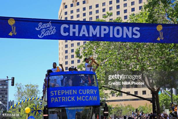 Stephen Curry of the Golden State Warriors holds up the Larry O'Brien Championship Trophy during the Golden State Warriors Victory Parade on June 12,...