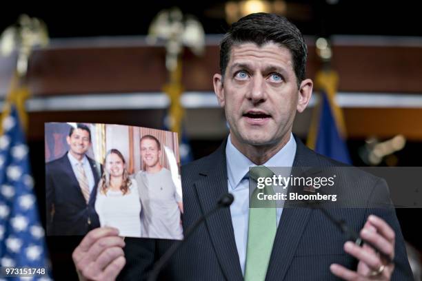 House Speaker Paul Ryan, a Republican from Wisconsin, speaks while holding a photograph of constituents affected by opioid abuse during a news...