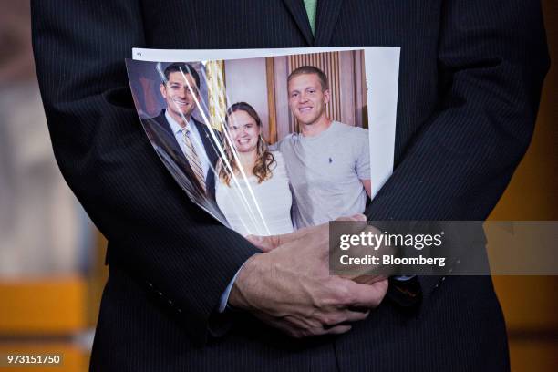 House Speaker Paul Ryan, a Republican from Wisconsin, holds a photograph of constituents affected by opioid abuse during a news conference on Capitol...