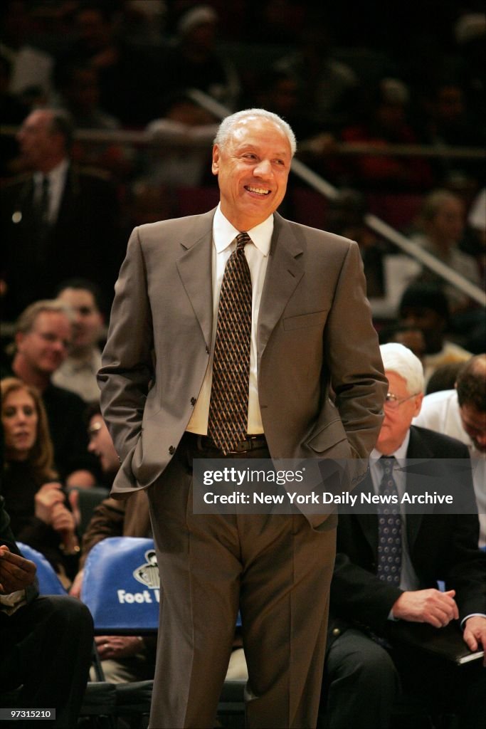 New York Knicks' coach Lenny Wilkens smiles as an announcer 