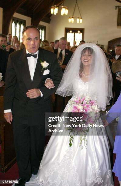 Mayor Rudy Giuliani walks Diane Gorumba down the aisle during her wedding to New York City Police Officer Michael Ferrito at St. James Lutheran...