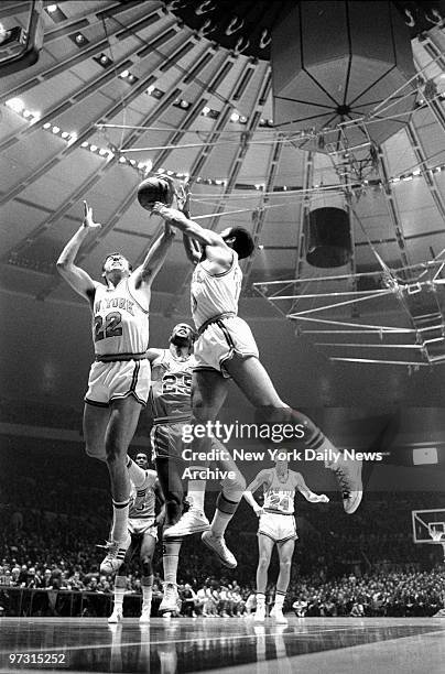 New York Knicks' Dave DeBusschere and Walt Frazier get position on Baltimore Bullets' Gus Johnson for a rebound in the first period.