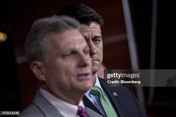 House Speaker Paul Ryan, a Republican from Wisconsin, listens as Representative Buddy Carter, a Republican from Georgia, left, speaks during a news...