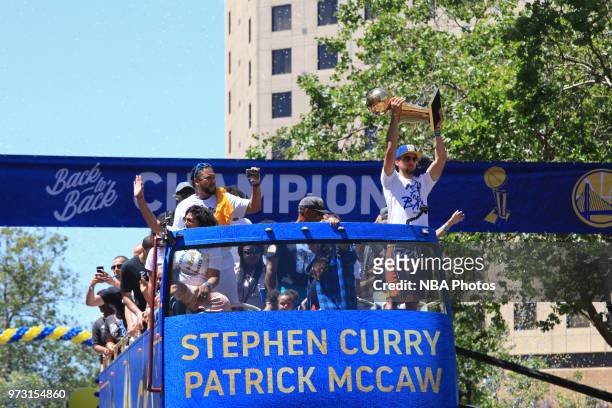 Stephen Curry of the Golden State Warriors holds up the Larry O'Brien Championship Trophy during the Golden State Warriors Victory Parade on June 12,...