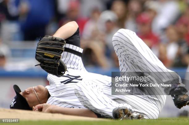 New York Yankees' starting pitcher Jeff Karstens is knocked to the ground after being hit by Boston Red Sox's Julio Lugo's line drive in the first...