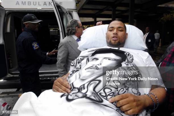Joseph Guzman leaves Mary Immaculate Hospital, where he has been recovering since he was shot by police on Nov. 25, and is taken to a waiting...
