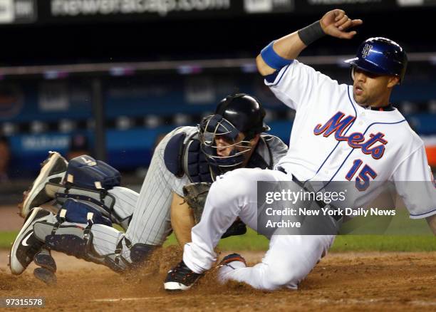 New York Mets' Carlos Beltran beats the tag of Minnesota Twins' catcher Joe Mauer to score in the eighth inning of a game at Shea Stadium. The Mets...
