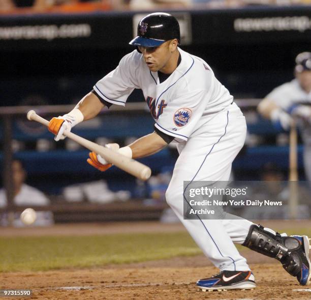 New York Mets' Carlos Beltran bunts for a single in the fourth inning against the Pittsburgh Pirates at Shea Stadium. Beltran scored twice during his...