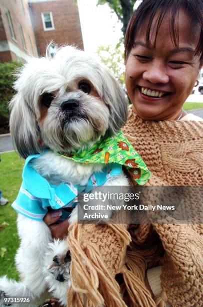 McDuff, a Shih Tzu wearing a baby Gap t-shirt, with owner Teresa Major at St. Ehrem's church for Deacon Bill Horn at the blessing of the animals ....