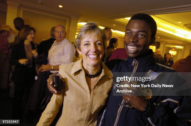 Trisha Meili, the jogger who was beaten and raped in Central Park in 1989, gets a hug from runner Boitumeno Kgomo, a security guard for Chubb...