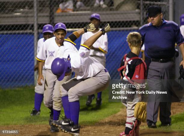 Jorge Lopez of the Harlem Little League team lands hard on home plate after hitting a home run against Maryland's state champs in a regional game in...