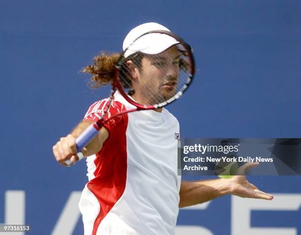 Jose Acasuso of Argentina hits a backhand return shot during his 2007 U.S. Open match against Andy Roddick of the United States, in Arthur Ashe...