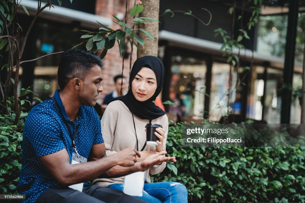 Young adult couple taking a break from business during an event