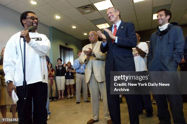 Gov. George Pataki applauds as he meets with director Spike Lee at Steiner Studios in the Brooklyn Navy Yard, where Lee is filming his new movie,...