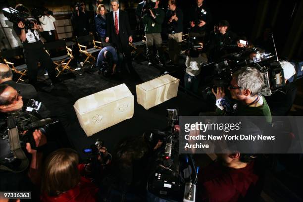 Media surround two ossuaries that filmmakers, including James Cameron, believe carried the remains of Jesus Christ and Mary Magdalene, during a news...
