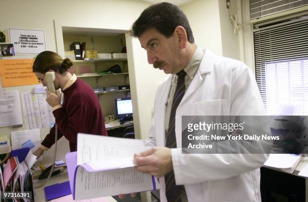 Medical Director Dr. Stephen Levin looks over some paper work at a medical screening clinic for World Trade Center rescue workers at Mt. Sinai...