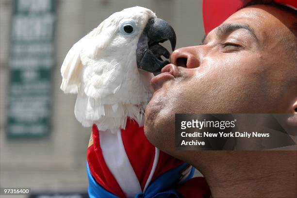 Jose Mendel gets an affectionate peck from Jossie as they proceed up the Grand Concourse in the Bronx during the annual Puerto Rican Day Parade.