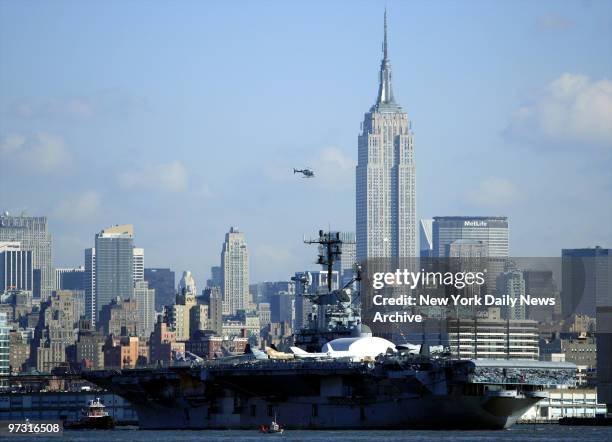 Tug boats guide the USS Intrepid down the Hudson River to Bayonne, N.J., where it will undergo a two-year, $60 million renovation. The historic...